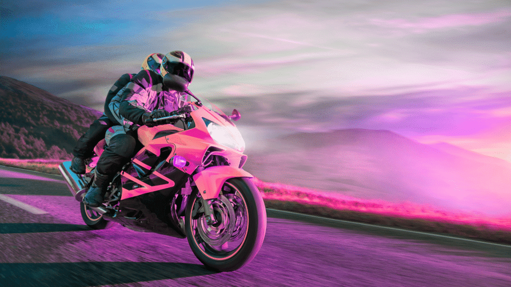 Motorcyclist riding at high speed with motion blur, wearing a helmet and protective gear.