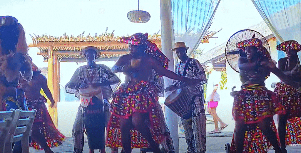 Traditional Tchianda dancers and drummers performing in colorful attire at a cultural event in Luanda, Angola, showcasing Angolan heritage through rhythm and movement.