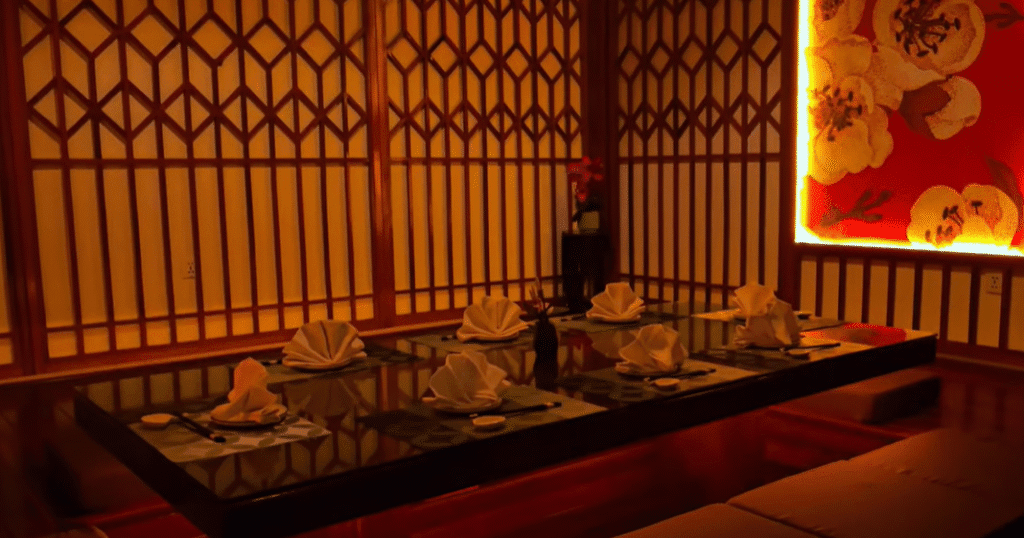 Elegant private dining area at Sakura Japanese Restaurant in Luanda, with traditional Japanese decor, warm lighting, and a beautifully arranged table setting.