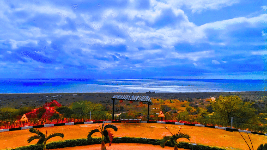 Scenic viewpoint at Miradouro da Lua overlooking Angola's wild coastline under a dramatic blue sky.
