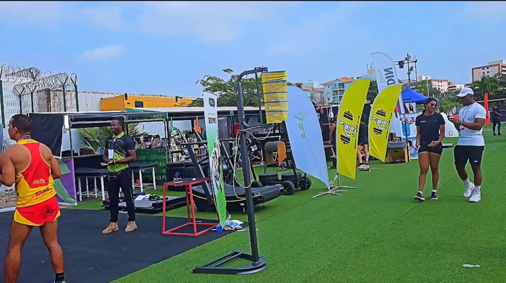 Fitness equipment zone at the Talatona Fitness Fair 2025, with exercise machines, banners and branded stands showcasing wellness products and workout gear.